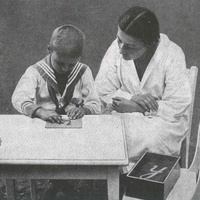 Lettere smerigliate The teacher has shown the child how to trace the shape of the letter with the index and middle finger, at the same time making the sound of the letter. Photograph taken in a Berlin Children's House around 1927 - T. Müller, R. Schneider, <em>Lehrmaterialien 1913-1935. Möbel und Architektur. Techning Meterials 1913-1935. Furniture and Architecture</em>, München, Prestel Verlag, 2002, p.101$$$468