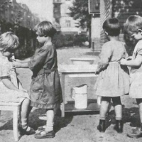 Aiuto reciproco nel vestirsi Children helping each other with getting dressed and fastening shoes. Children's House, Leopold-platz, Berlin-Wedding 1928 - T. Müller, R. Schneider, <em>Lehrmaterialien 1913-1935. Möbel und Architektur. Techning Meterials 1913-1935. Furniture and Architecture</em>, München, Prestel Verlag, 2002, p.78$$$408